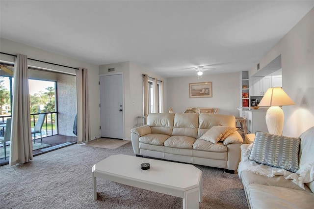 living room with light colored carpet and ceiling fan