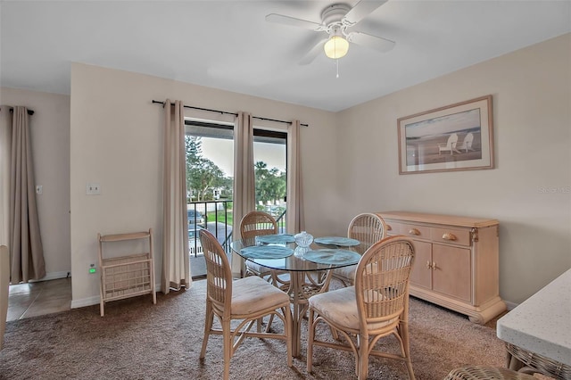 carpeted dining area featuring ceiling fan