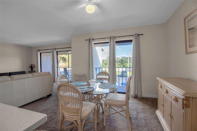 carpeted dining area featuring ceiling fan