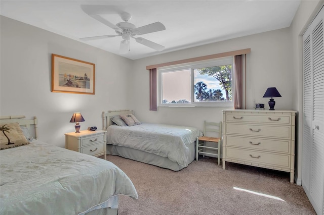 bedroom featuring a closet, ceiling fan, and light colored carpet