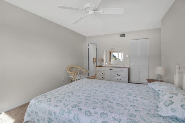 bedroom featuring ceiling fan, a closet, and light carpet