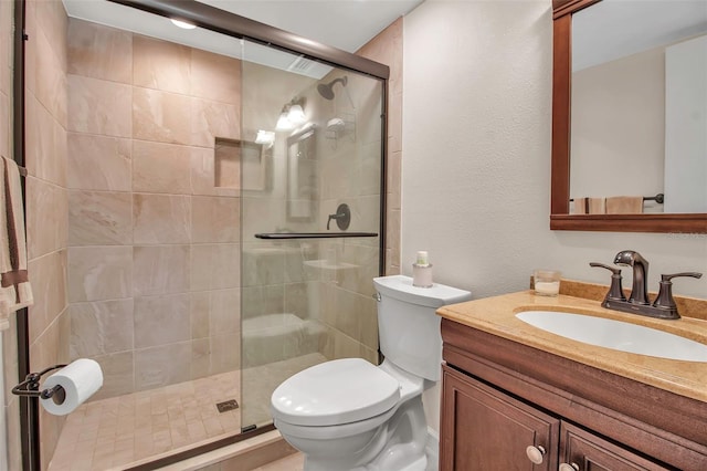 bathroom featuring vanity, toilet, and an enclosed shower