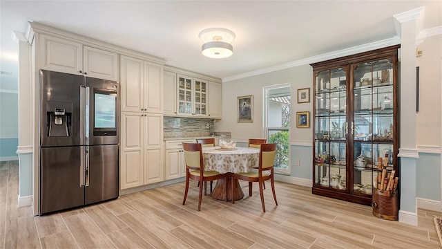 dining area featuring crown molding and light hardwood / wood-style floors