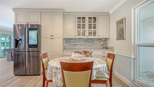 dining space with crown molding