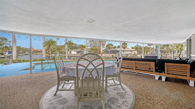 sunroom / solarium with a water view