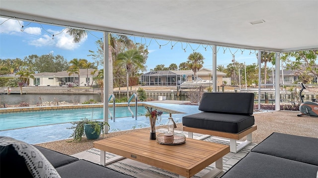 view of pool with a water view and a patio area