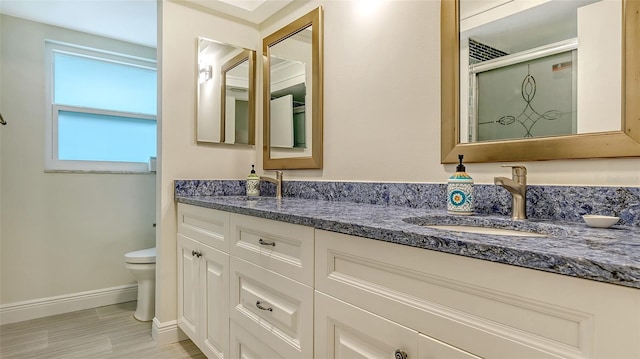 bathroom featuring an enclosed shower, vanity, and toilet