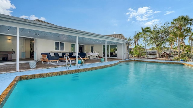 view of pool featuring an outdoor living space and a patio area