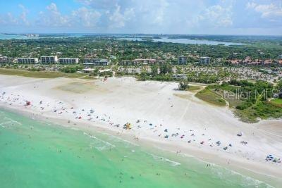 bird's eye view featuring a view of the beach and a water view