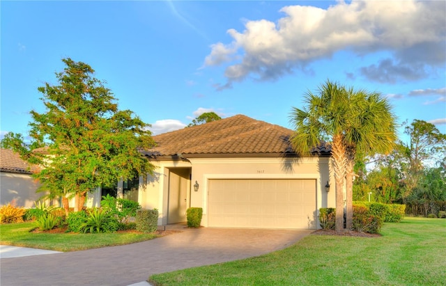 mediterranean / spanish home with a garage and a front lawn