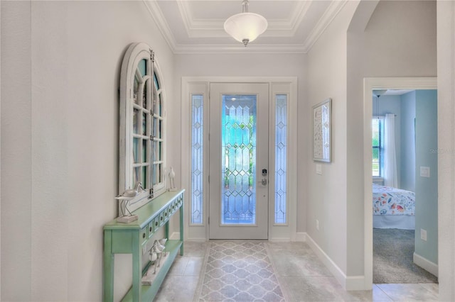 foyer entrance with crown molding and light tile patterned flooring