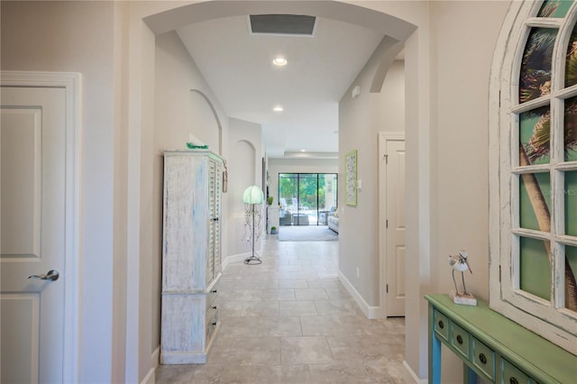 corridor with light tile patterned floors