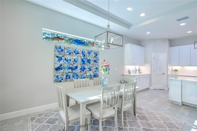 dining space with an inviting chandelier