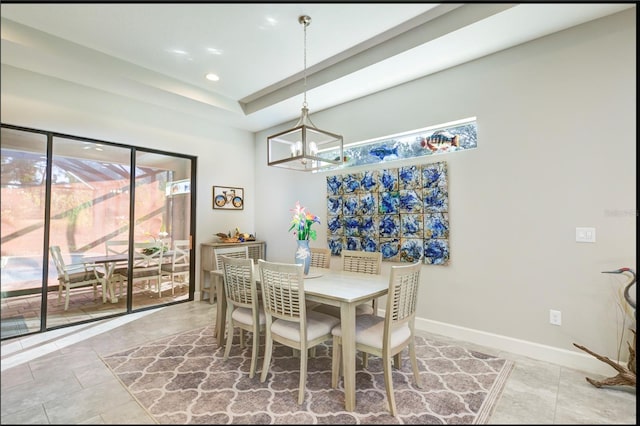 dining space featuring tile patterned flooring and an inviting chandelier