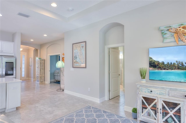 interior space featuring white cabinetry and stainless steel refrigerator