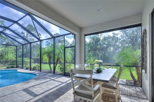 sunroom / solarium featuring a swimming pool