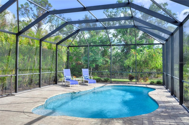 view of pool with a lanai and a patio area