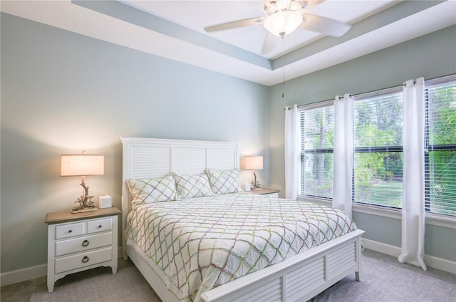 carpeted bedroom with ceiling fan and multiple windows