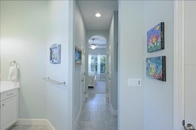 hall with light tile patterned floors