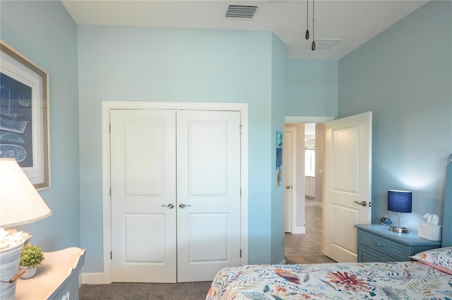 bedroom with a closet and dark colored carpet