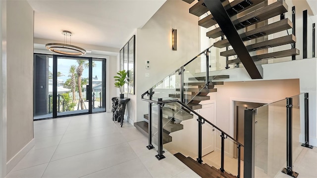 tiled entrance foyer featuring a chandelier