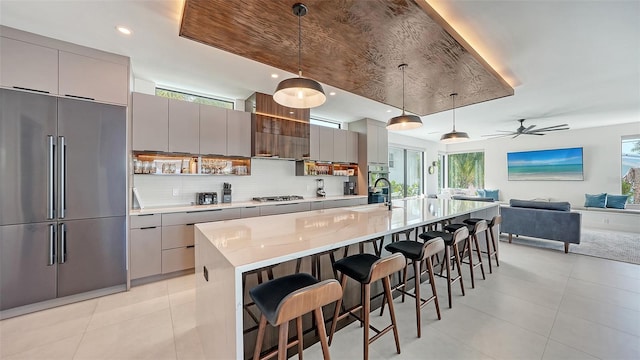 kitchen with a large island, hanging light fixtures, and appliances with stainless steel finishes