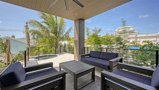 view of patio / terrace with an outdoor living space, a balcony, ceiling fan, and a jacuzzi