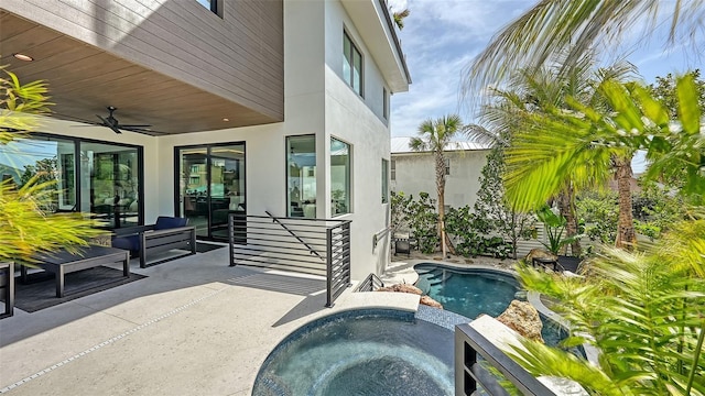 exterior space with ceiling fan, an in ground hot tub, and a patio