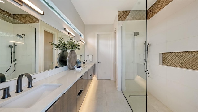 bathroom with tiled shower, vanity, and tile patterned flooring