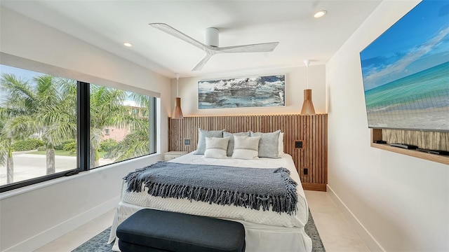 tiled bedroom featuring ceiling fan