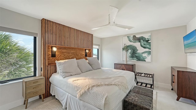 bedroom featuring multiple windows and ceiling fan