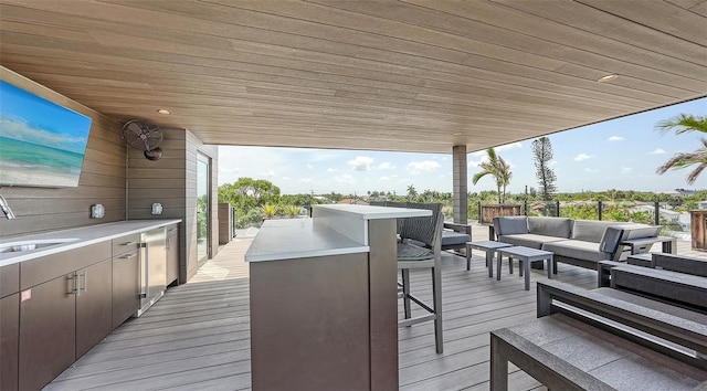 deck with outdoor lounge area and sink