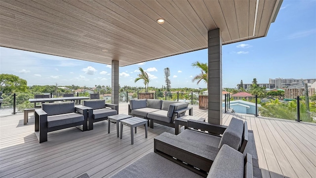 wooden terrace with an outdoor living space