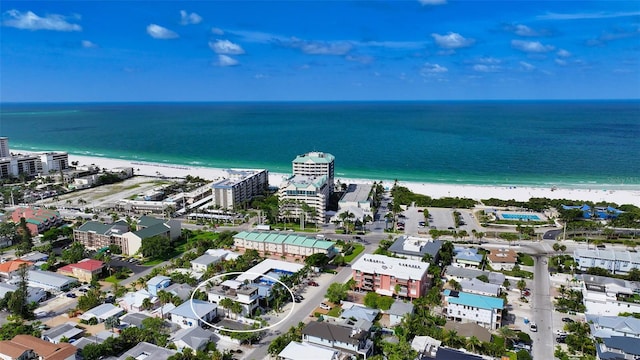 birds eye view of property with a beach view and a water view