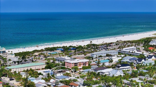 birds eye view of property with a water view and a view of the beach