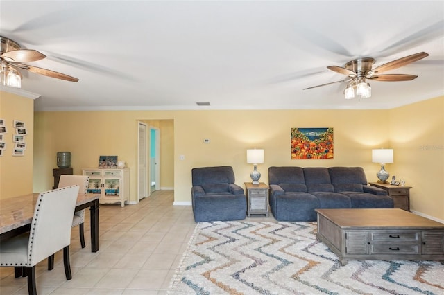 tiled living room with ceiling fan and ornamental molding