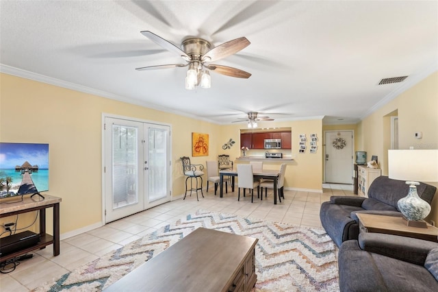 tiled living room with crown molding, french doors, and ceiling fan