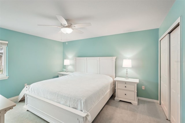 carpeted bedroom with ceiling fan and a closet