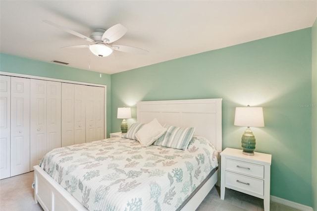 carpeted bedroom with ceiling fan and a closet