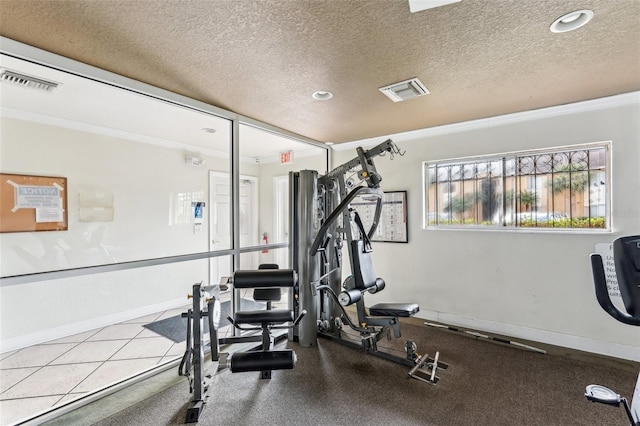 exercise area featuring crown molding and a textured ceiling