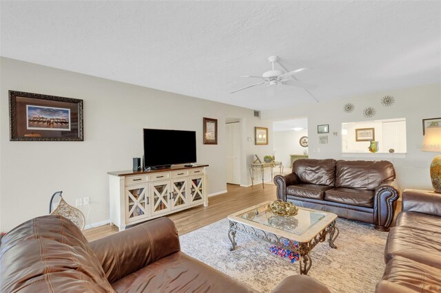 living room with ceiling fan and light hardwood / wood-style floors