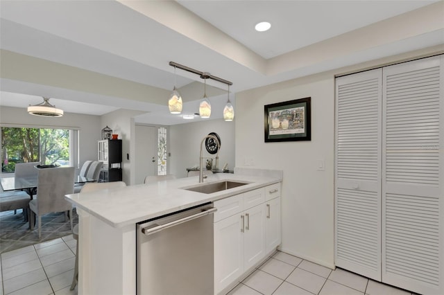 kitchen with dishwasher, kitchen peninsula, white cabinetry, and sink