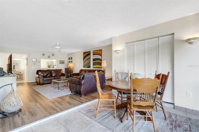 dining room with ceiling fan and light hardwood / wood-style floors