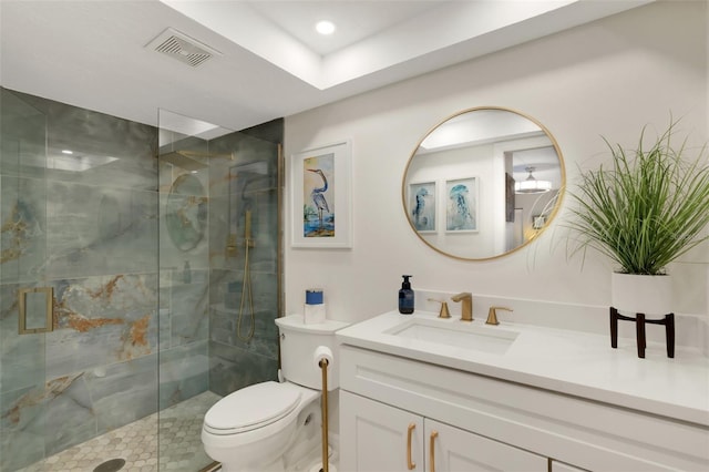 bathroom featuring vanity, an enclosed shower, and toilet