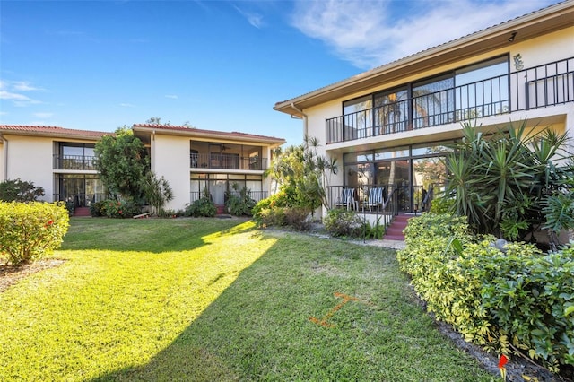 rear view of property featuring a yard