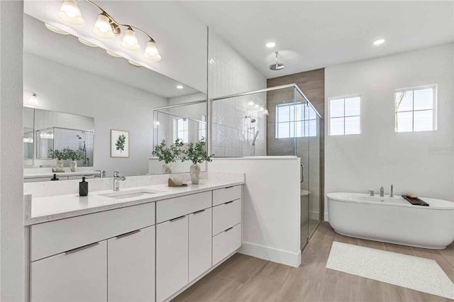 8007 Nevis Run, Bradenton, FL 34202 - full bath with a shower stall, vanity, recessed lighting, and a freestanding tub
