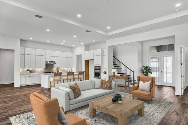 8007 Nevis Run, Bradenton, FL 34202 - living area featuring dark wood finished floors, recessed lighting, stairway, baseboards, and french doors