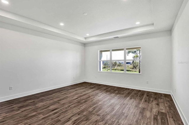 8007 Nevis Run, Bradenton, FL 34202 - unfurnished room with a tray ceiling, dark wood-style floors, baseboards, and recessed lighting