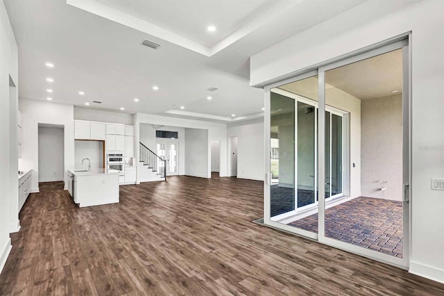 8007 Nevis Run, Bradenton, FL 34202 - unfurnished living room with dark wood-style floors, a sink, baseboards, and recessed lighting