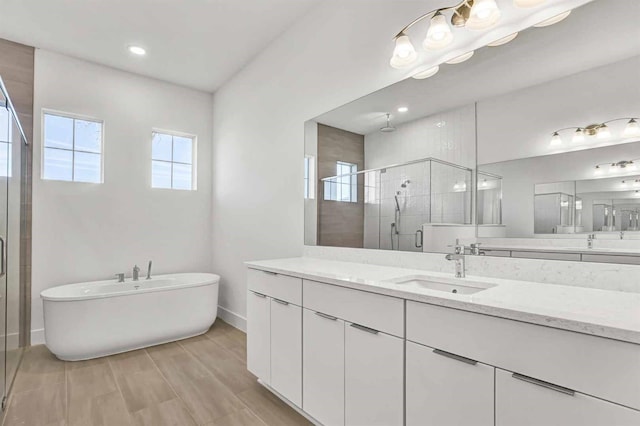 8007 Nevis Run, Bradenton, FL 34202 - bathroom featuring a stall shower, vanity, baseboards, a soaking tub, and recessed lighting
